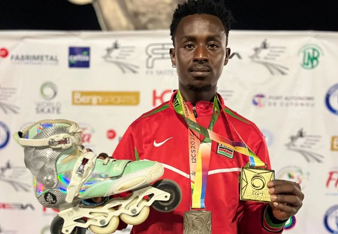 Kevin Kiarie Ruhiu poses with inline skates and medals