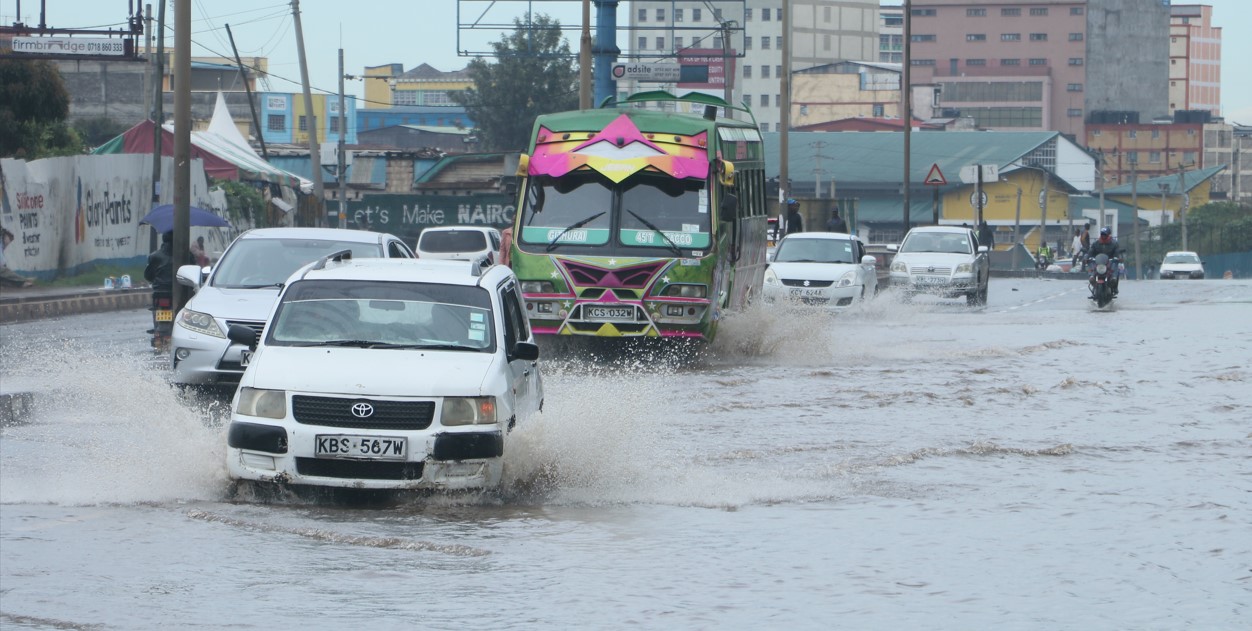 Vehicles drive through floodwater on Ring Road in Ngara, Nairobi