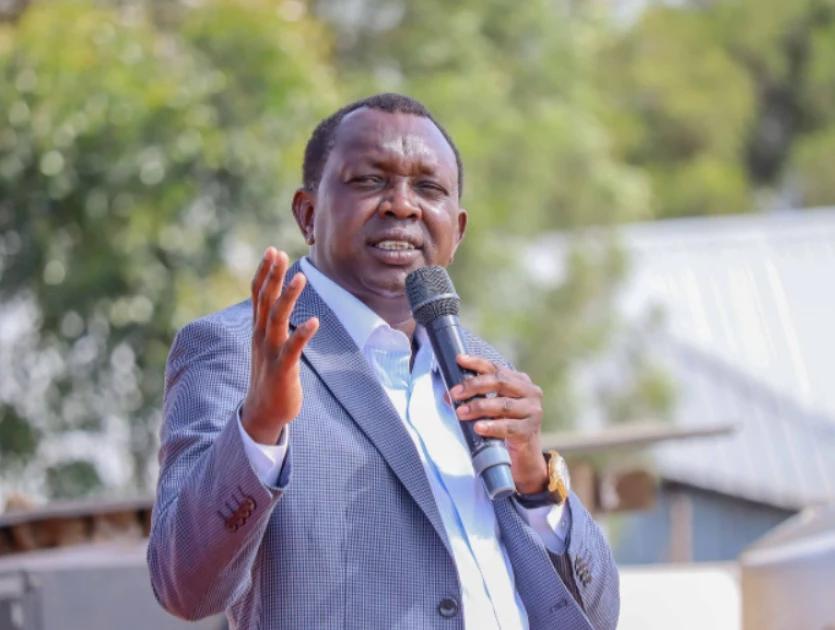 Kapseret MP Oscar Sudi speaks into a microphone during a public address.