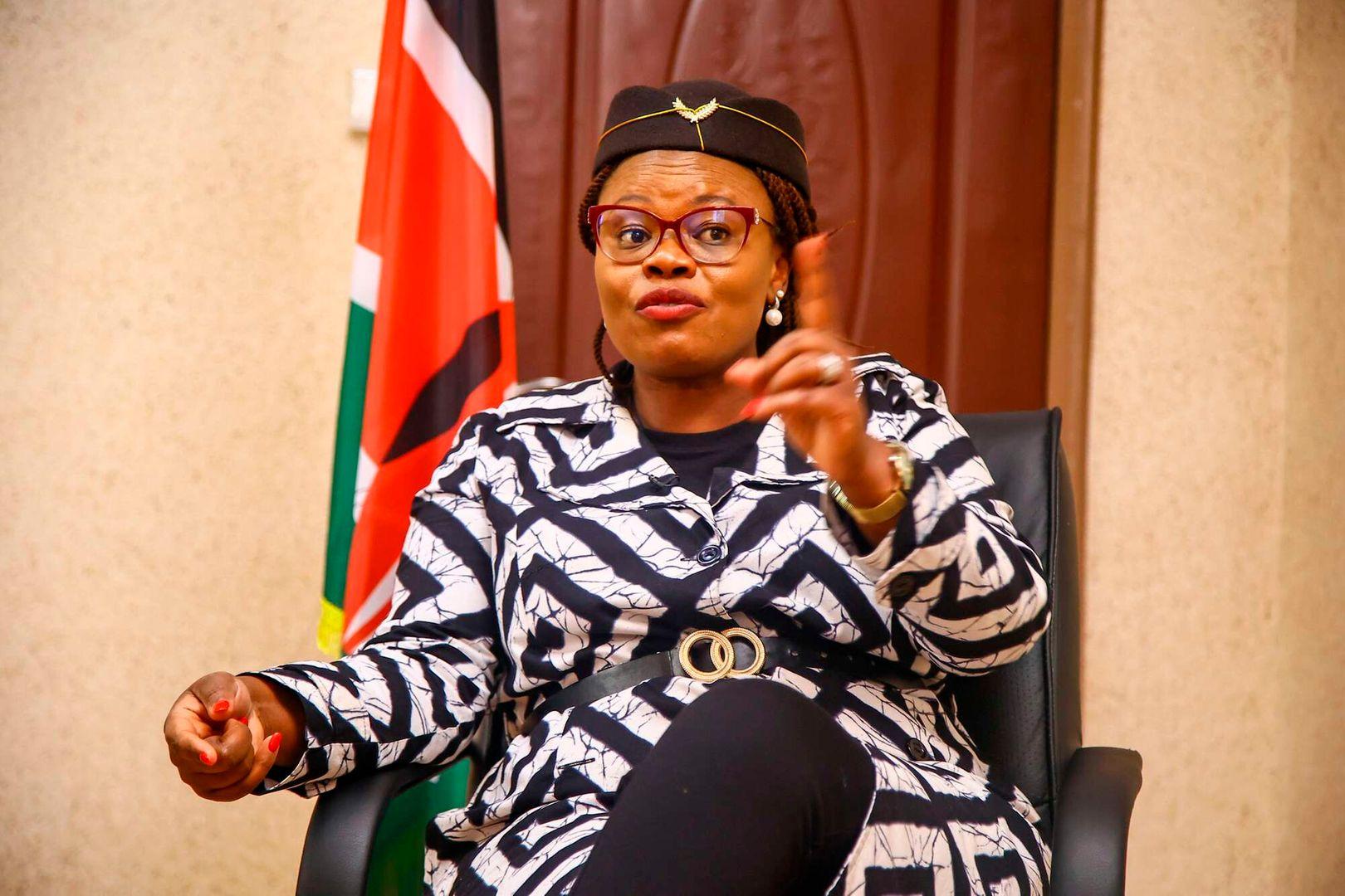 Githunguri MP Gathoni Wamuchomba wearing a blue hat and a patterned outfit at a public event.