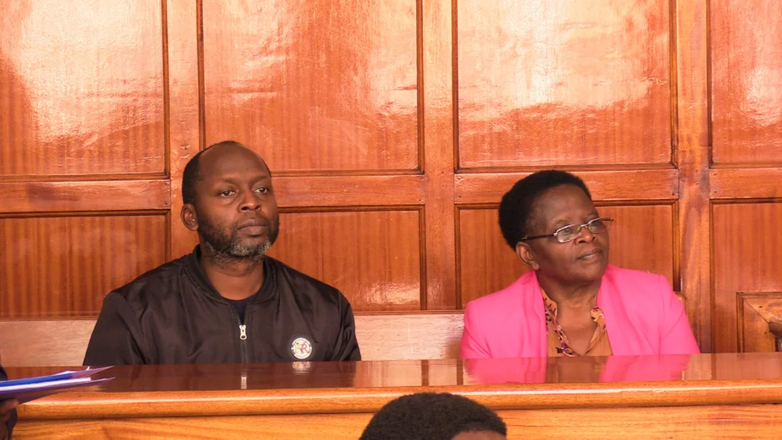 Rose Mbithe Mulwa seated beside a man during a court proceeding.